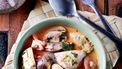 portrait of thai tom yam soup in a bowl on the wooden table