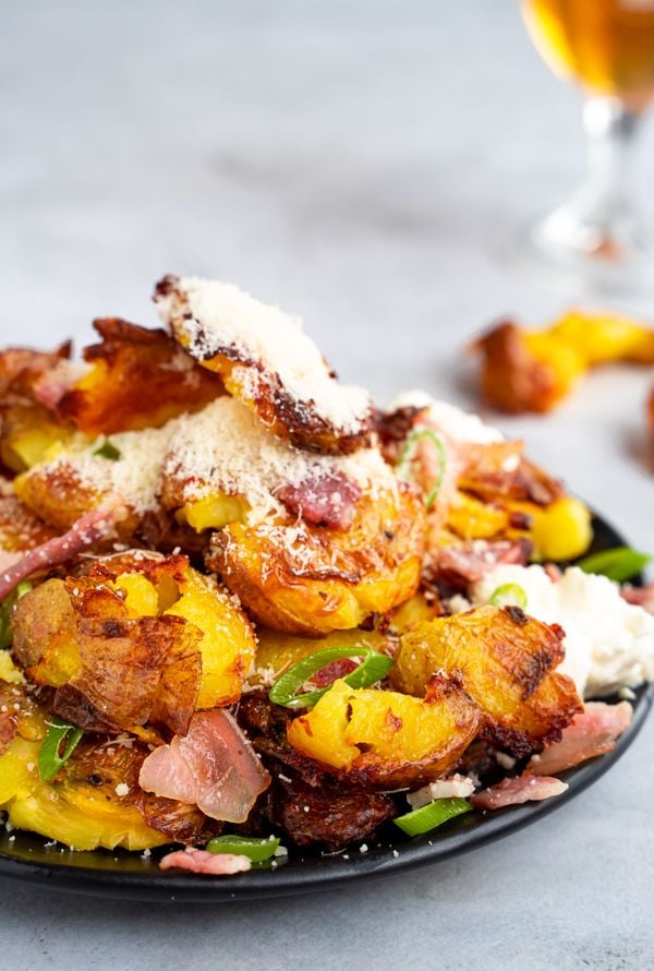 loaded crushed potatoes with bacon, parmesan and spring onion